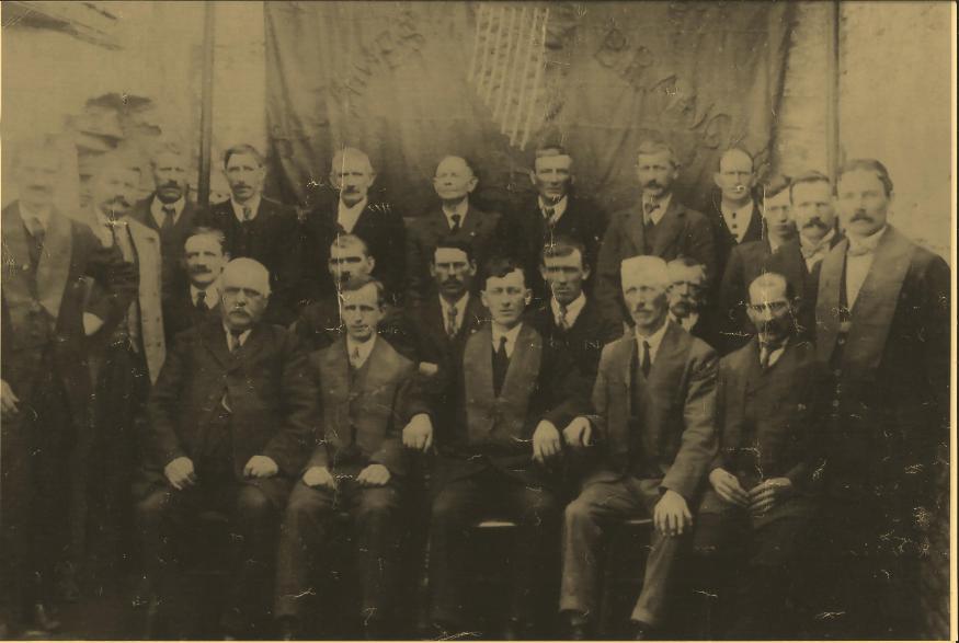Athboy Branch Ancient Order of Hibernians Standing back row L to R : unknown; Pat Peters; P Ward, Gillstown; Ml Fox, Otterstown; Rispin, Forge; unknown; John Fox, Castletown; Willie Reilly, Chapel St; Bill Doherty, Chapel St; unknown; Hugh Daly, Fair Green, Railway Guard; P Brennan, Trim Rd, Railway Man: Middle row seated ; unknown; unknown; unknown; Patrick Maye, Castletown, (Mason); Thomas Brown, Main Street, Harness maker: Front row: Garry, Connaught Street; unknown; unknown; James O'Brien, Connaught Street; Kellett: 